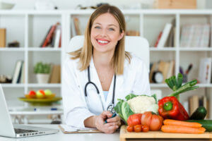 Doctor surrounded by healthy vegetables