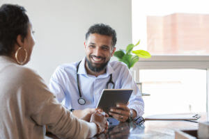 Family Doctor Discussing report with Patient